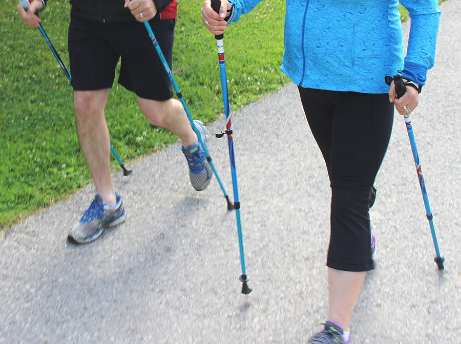Nordic pole walking waist down shot 2 people Nordic pole walking waist down shot 2 people