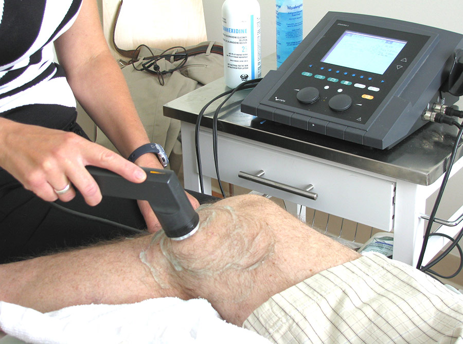Physiotherapy-services patient with ultrasound machine Physiotherapy-services patient with ultrasound machine